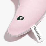Pink travel pillow with buckwheat hulls